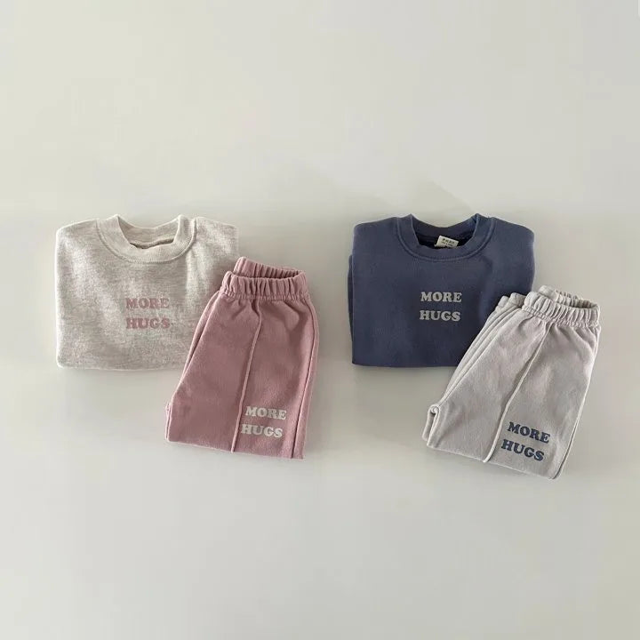 Both More Hugs tracksuit sets laid flat