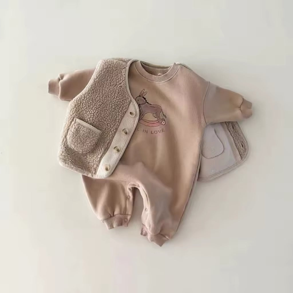 Pink rocking horse baby romper styled with sherpa vest