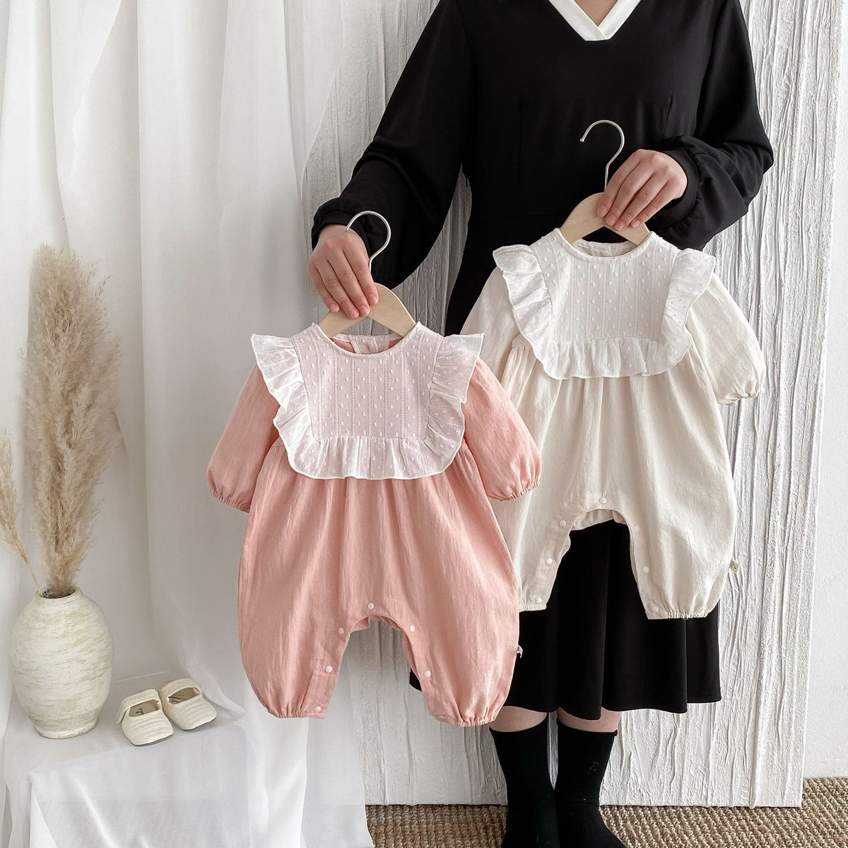 Pink and beige lace collar rompers on hangers