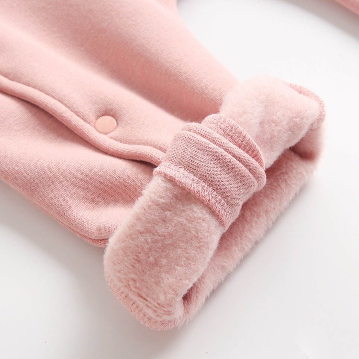 Close-up of fleece-lined cuff on pink jumpsuit