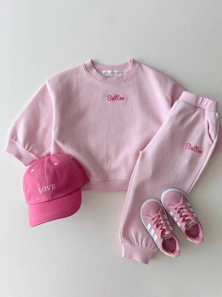Pink sweatshirt and joggers tracksuit with pink cap and sneakers