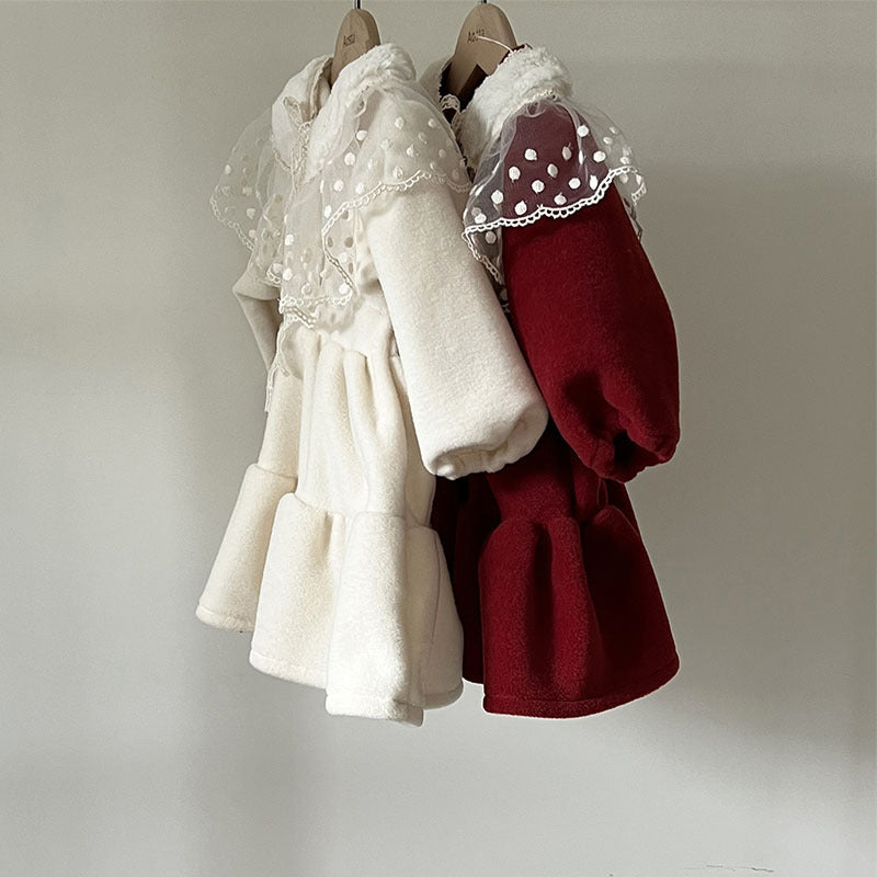 Cream and red princess dresses with lace collars on hangers