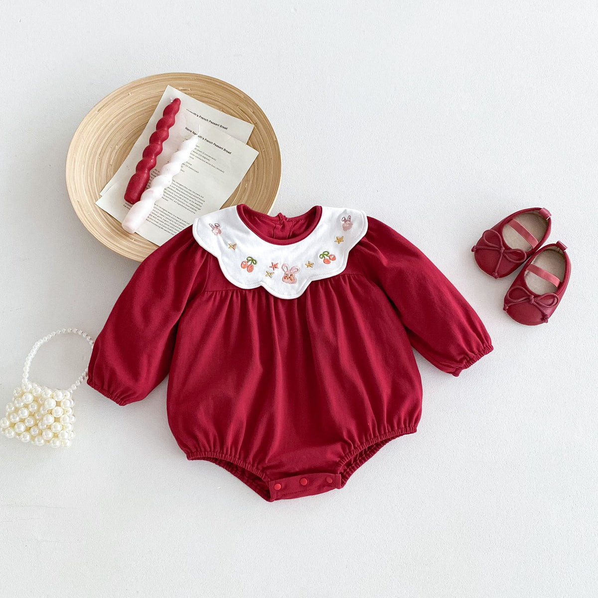 Red baby romper with white scalloped collar embroidered with berries