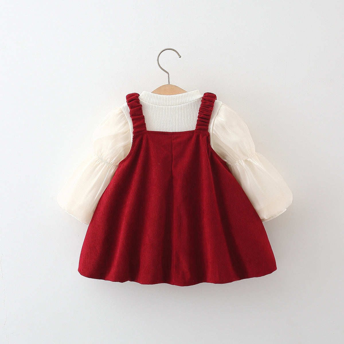 Red corduroy suspender skirt over cream long sleeve top, baby girl fall outfit