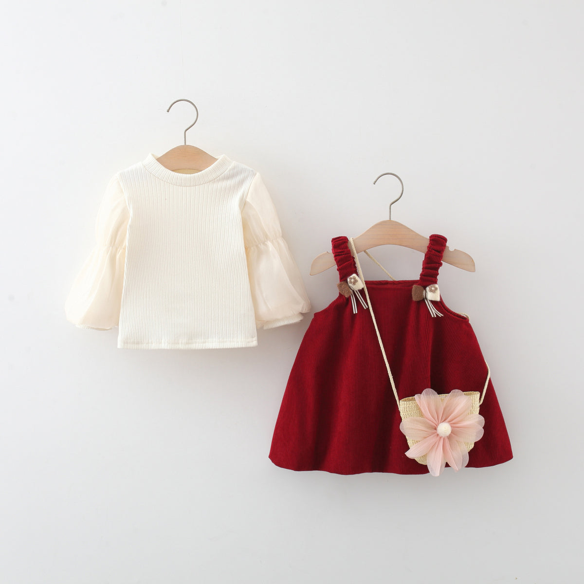 Red corduroy suspender skirt and cream long sleeve top shown separately
