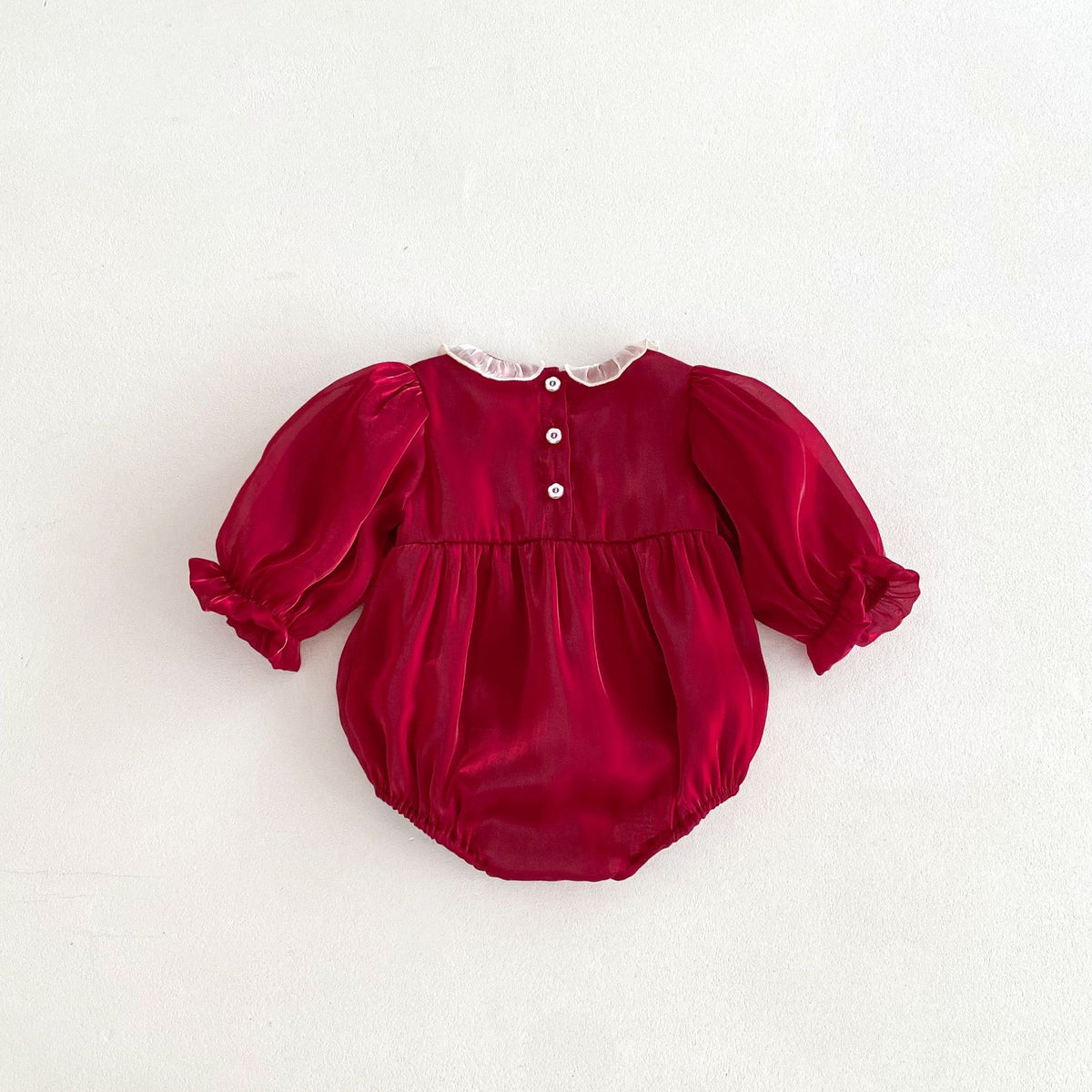 Back of red baby romper with buttons