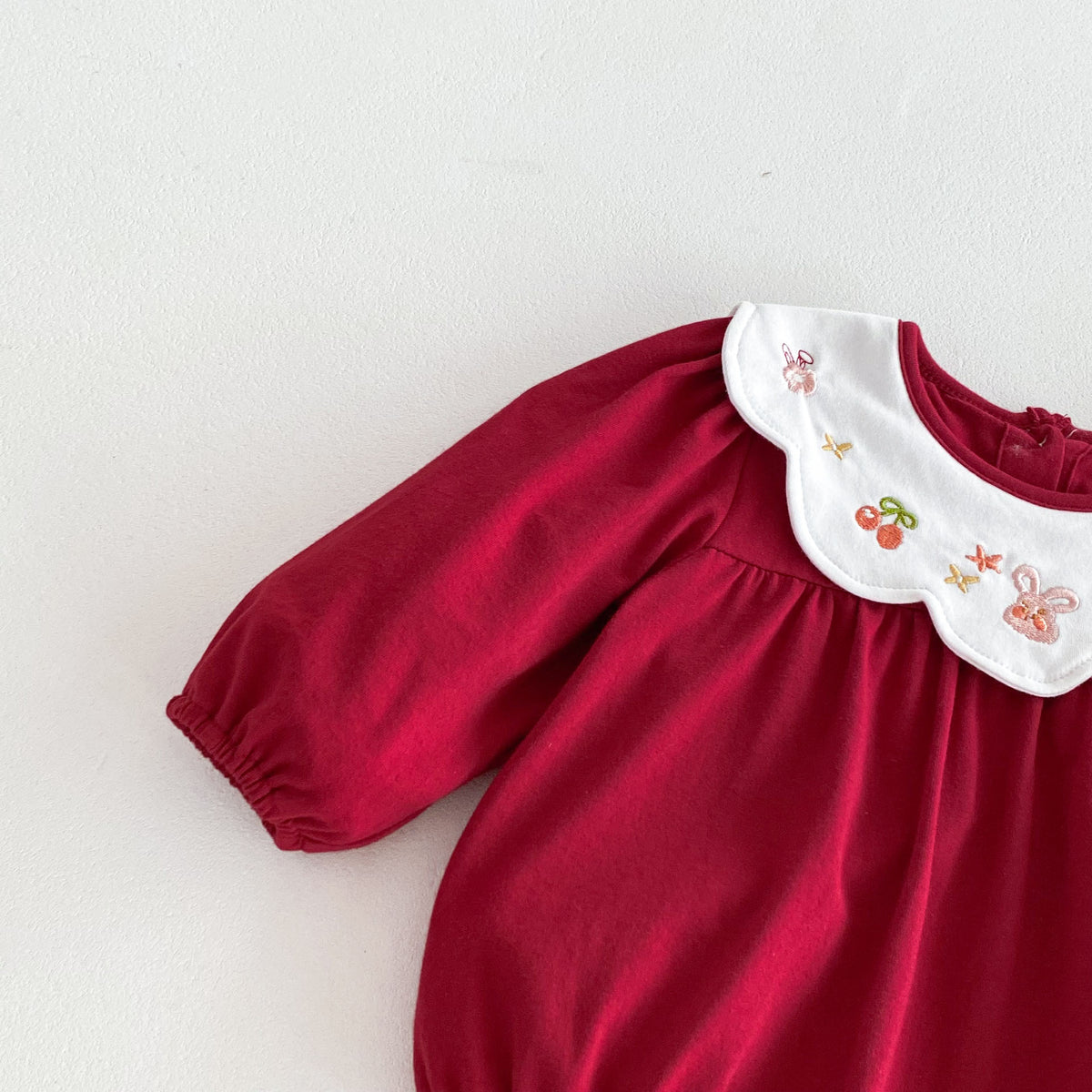 Long sleeve and embroidered collar on red baby romper