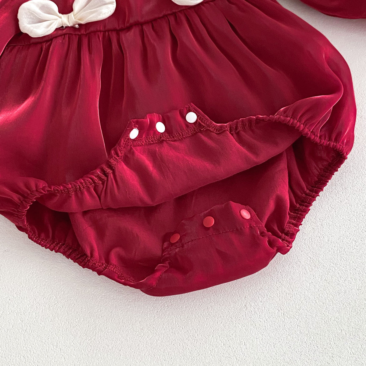 Close-up of snap crotch on red baby romper