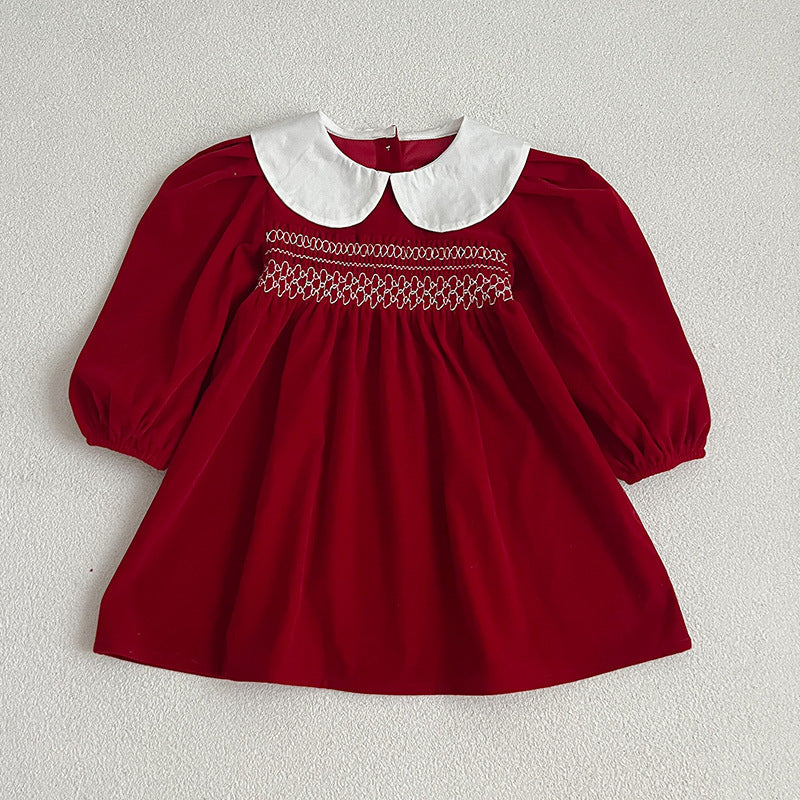 Red smocked baby dress with white Peter Pan collar