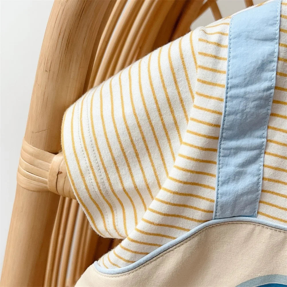 Close-up of blue shoulder strap on striped romper