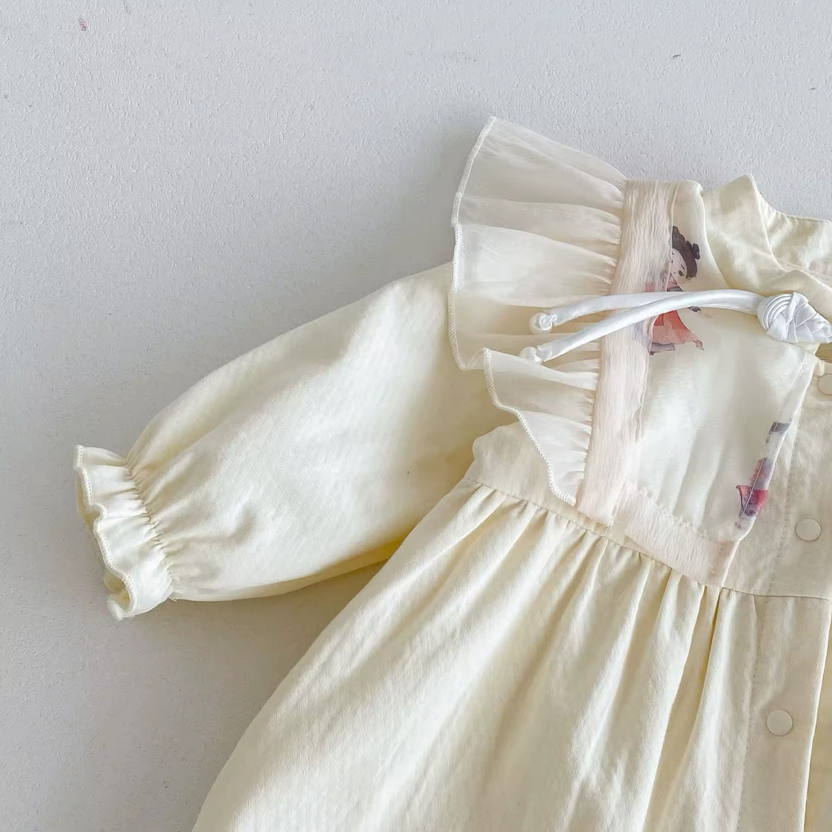 Close-up of ruffle shoulder and elastic cuff