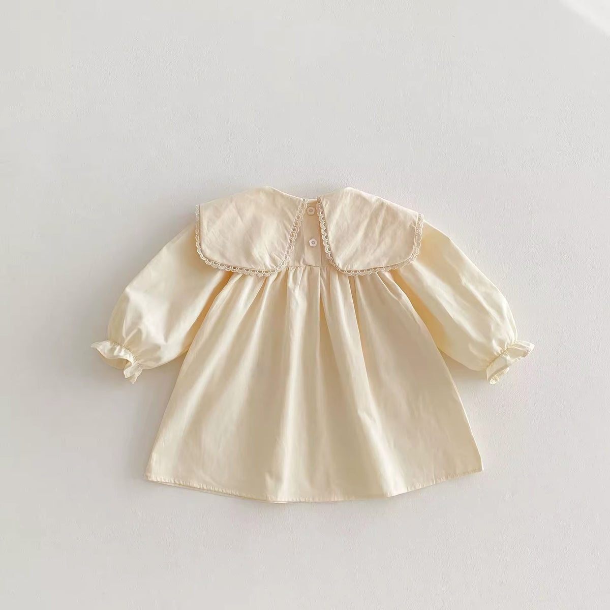 Back view of cream sailor collar toddler dress