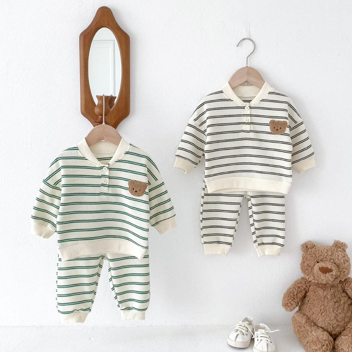 Green and gray striped bear sweatshirt sets on hangers