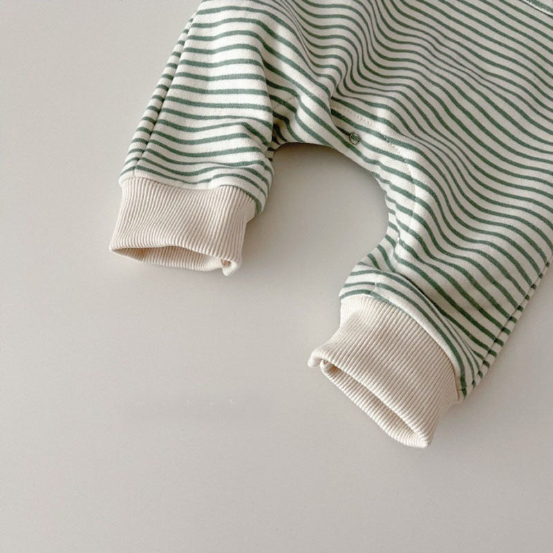 Close-up of ribbed ankle cuff on green striped baby romper