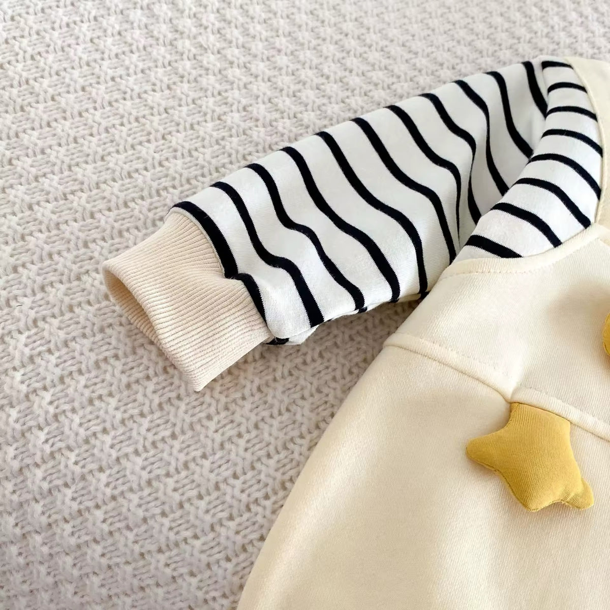 Close-up of striped sleeve and 3D star