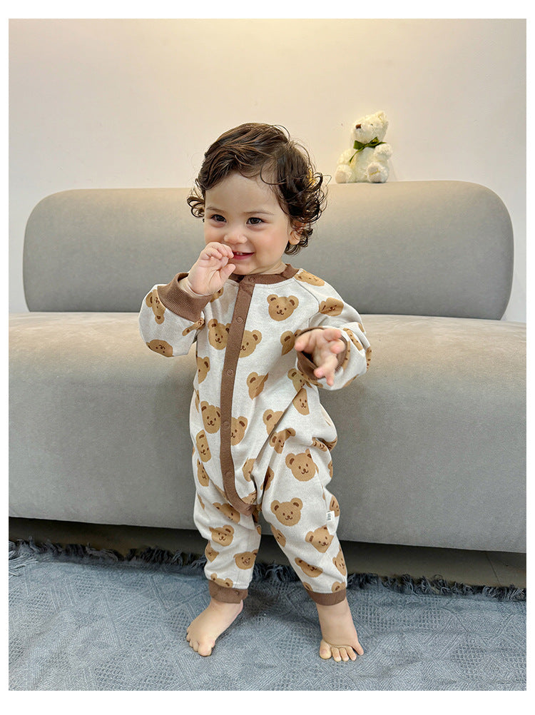 Toddler walking in beige teddy bear jumpsuit