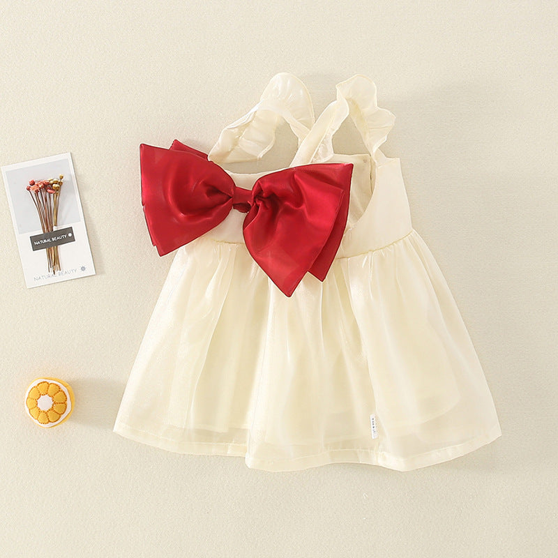 Cream tulle party dress with red bow, angled view