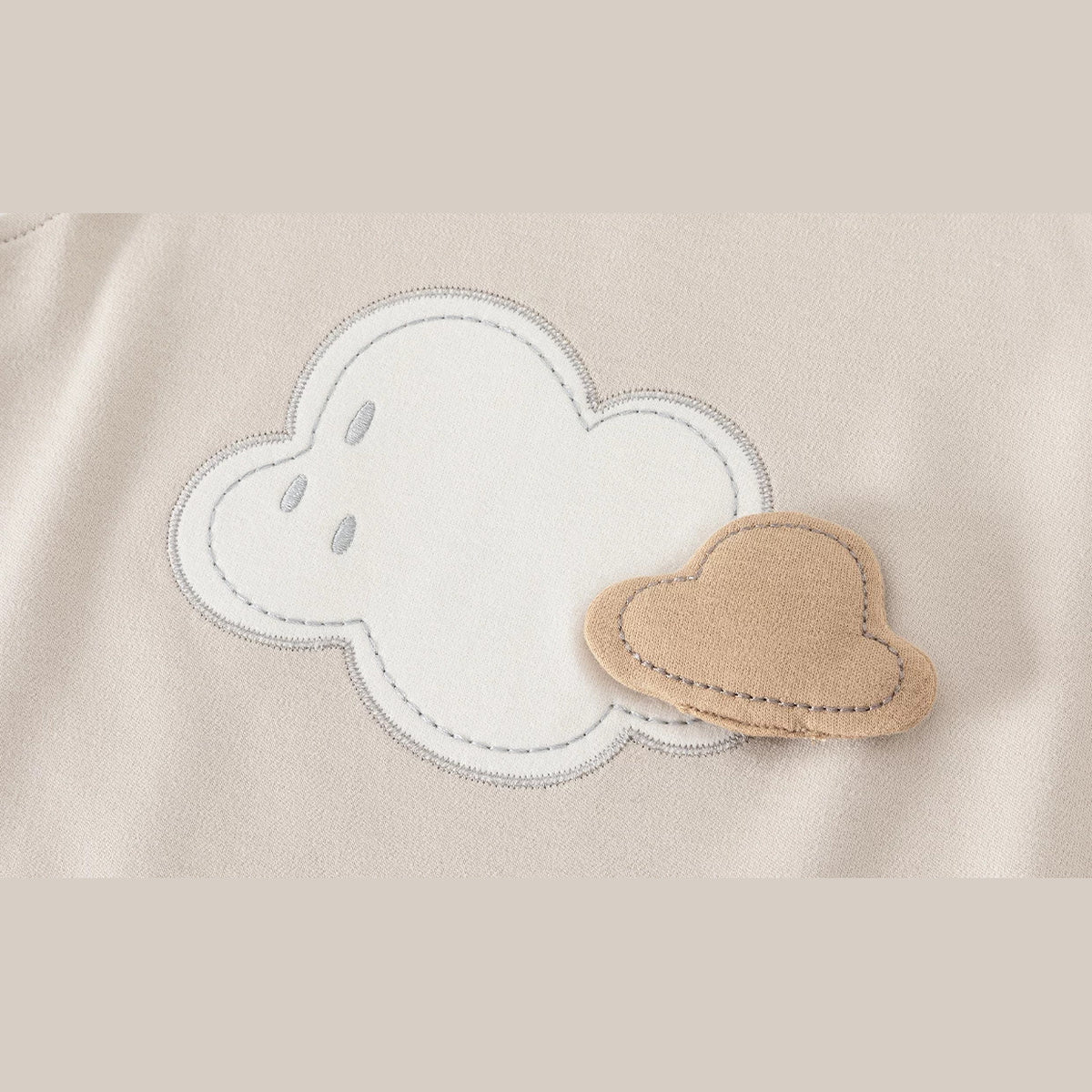 Close-up of the embroidered cloud applique with a felt hat