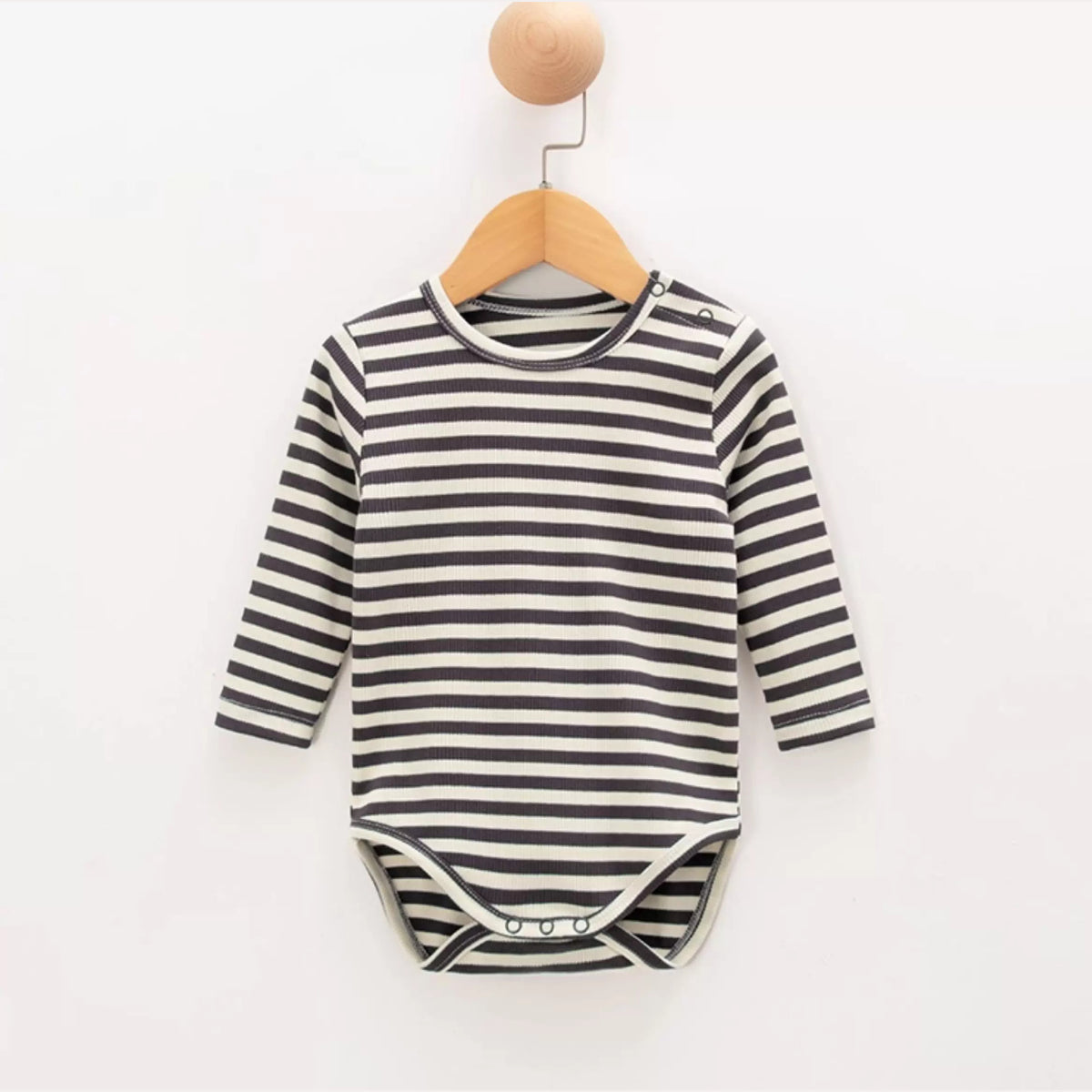 Charcoal stripe ribbed baby onesie on a wooden hanger