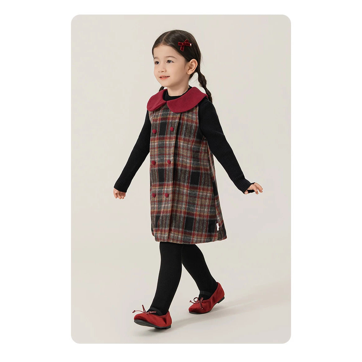Girl walking in a burgundy-collar plaid pinafore dress