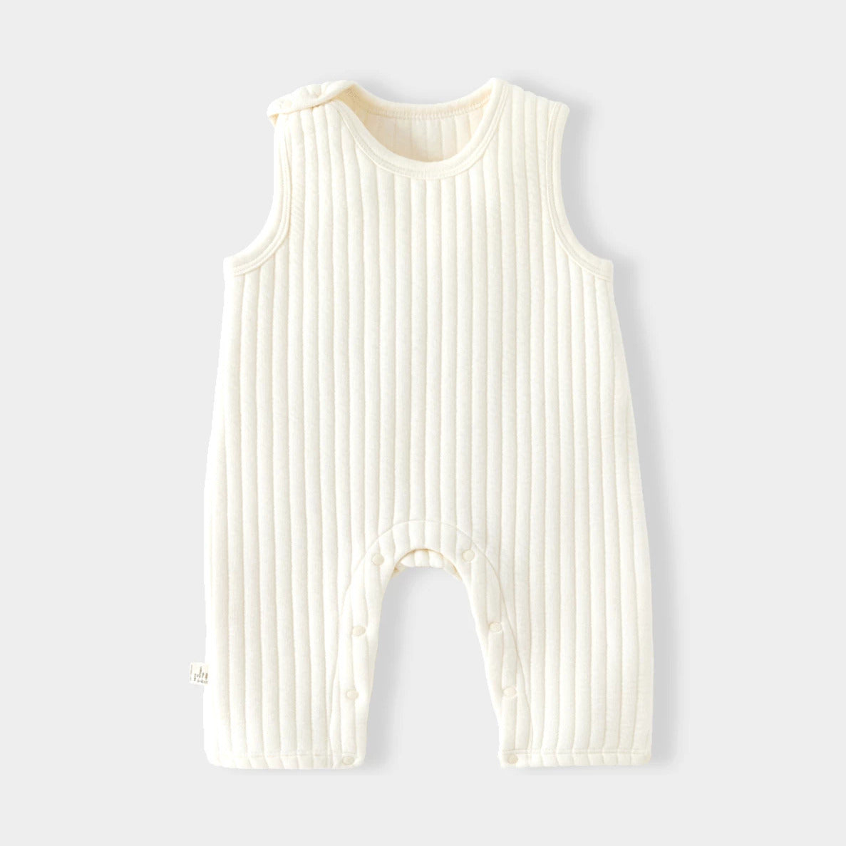 Cream quilted sleeveless baby romper with ribbed channel stitching, flat lay