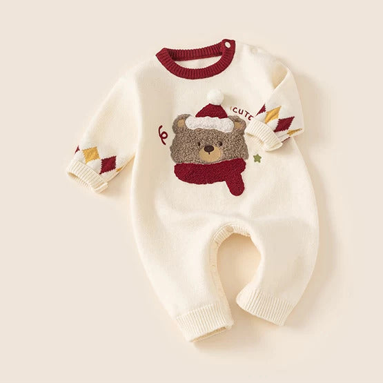 Cream bear knit romper with red collar and argyle cuffs, flat lay