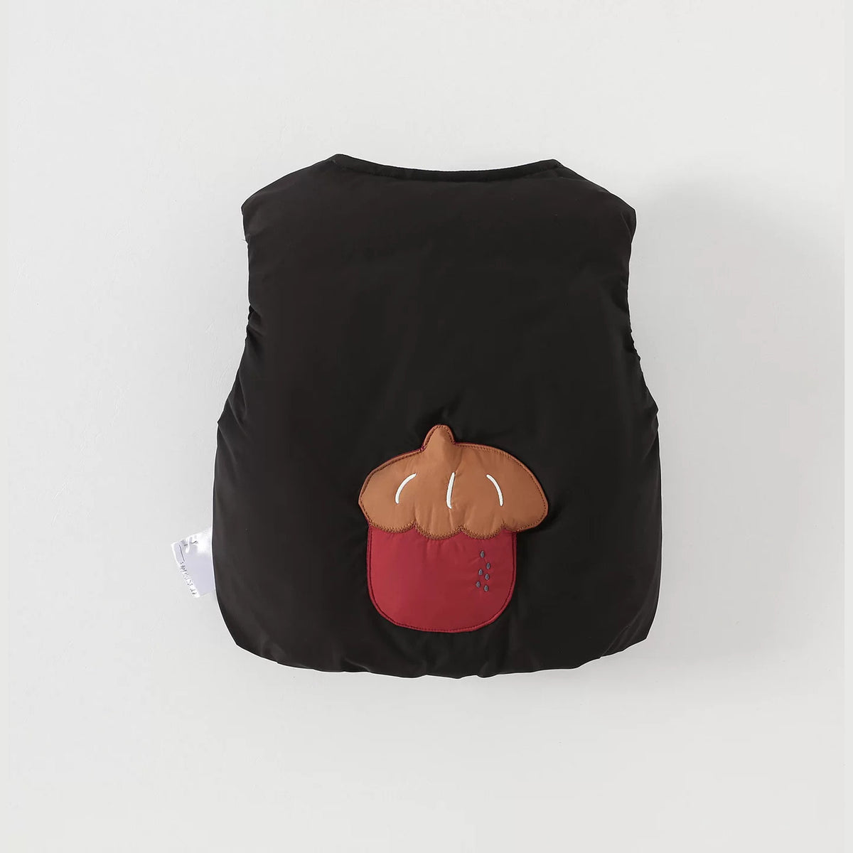 Black baby down vest with a puffy acorn appliqué on the back