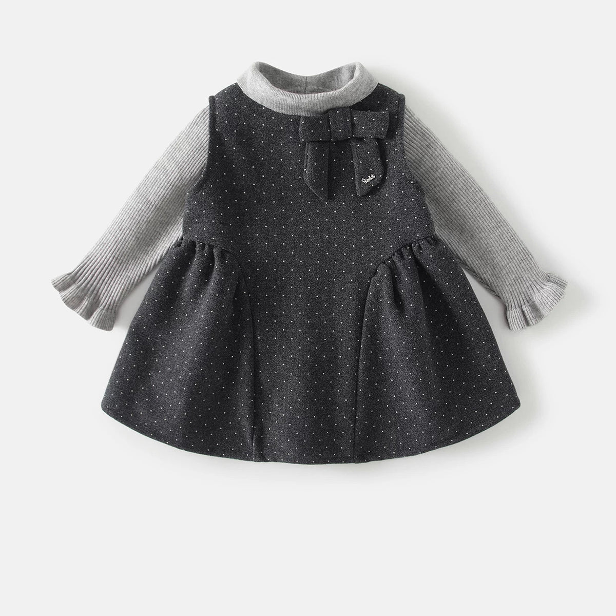 Charcoal dotted pinafore dress with grey ribbed ruffle-cuff top, toddler set flat lay