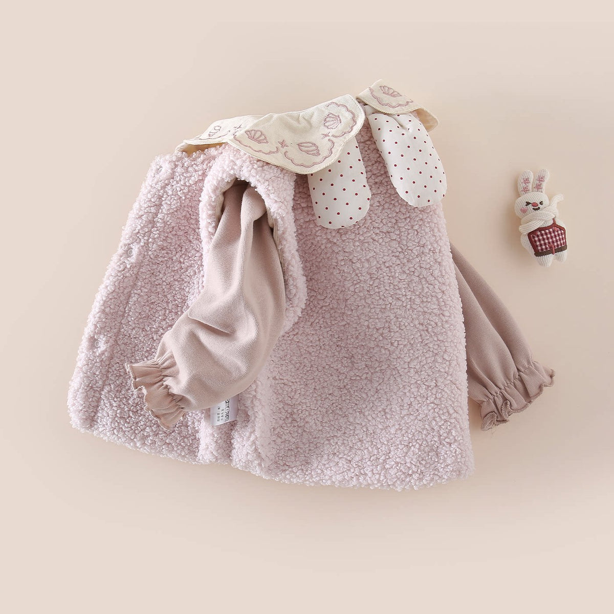Back view of the sherpa vest and petal collar top set