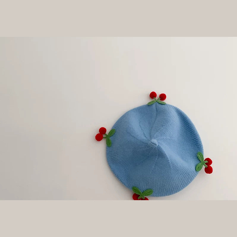 Sky Blue knit baby beret with crochet cherries, flat lay