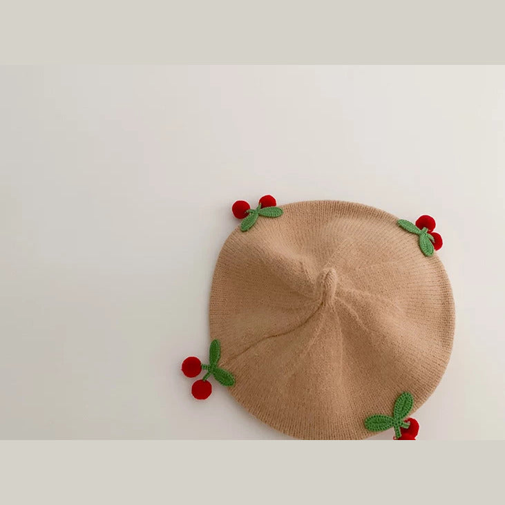 Camel knit baby beret with crochet cherries, flat lay