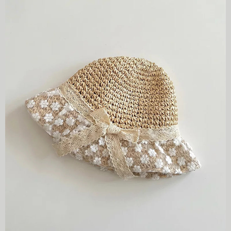 Side view of natural straw hat with daisy lace brim
