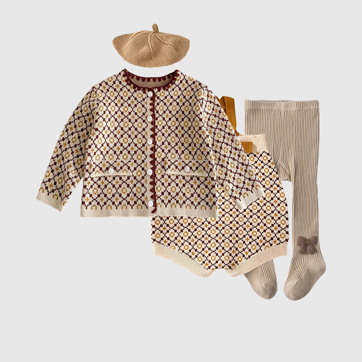 Knit cardigan, romper, beret and tights complete baby outfit, flat lay