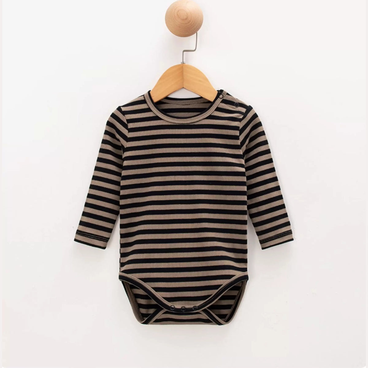Mocha stripe baby bodysuit hanging on a wooden hanger