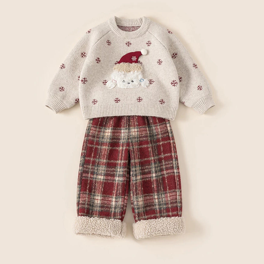 Oatmeal snowflake knit sweater with red pom-pom hat puppy and red plaid sherpa-cuff pants, flat lay