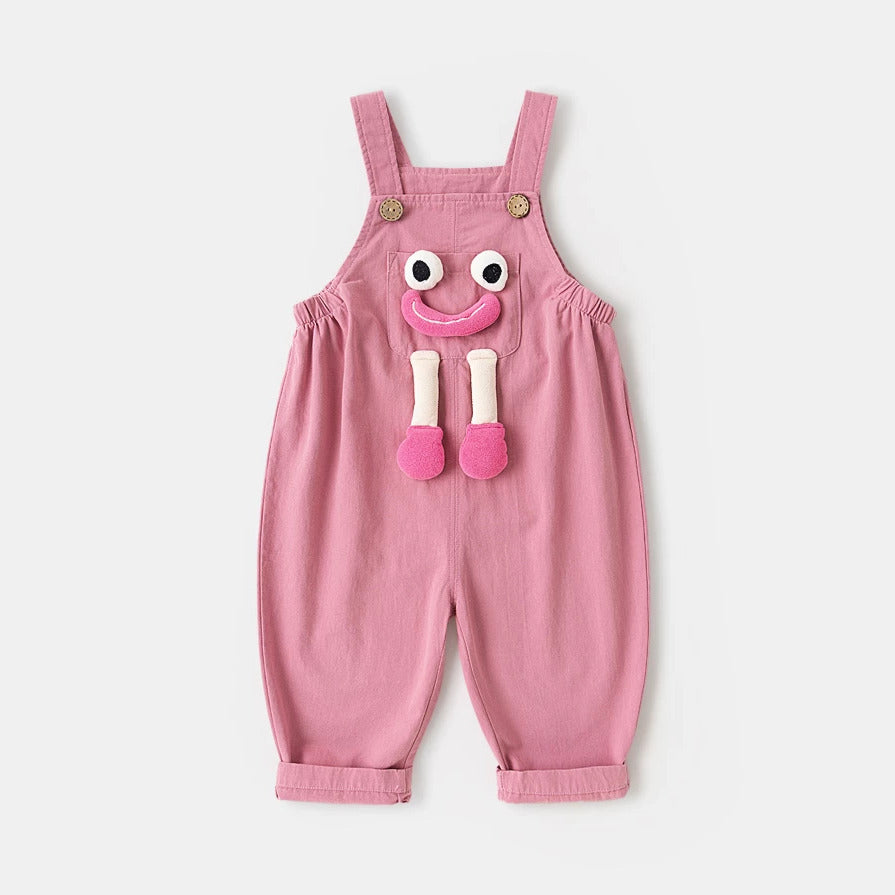 Pink cotton kids overalls with 3D smiley face pocket, flat lay