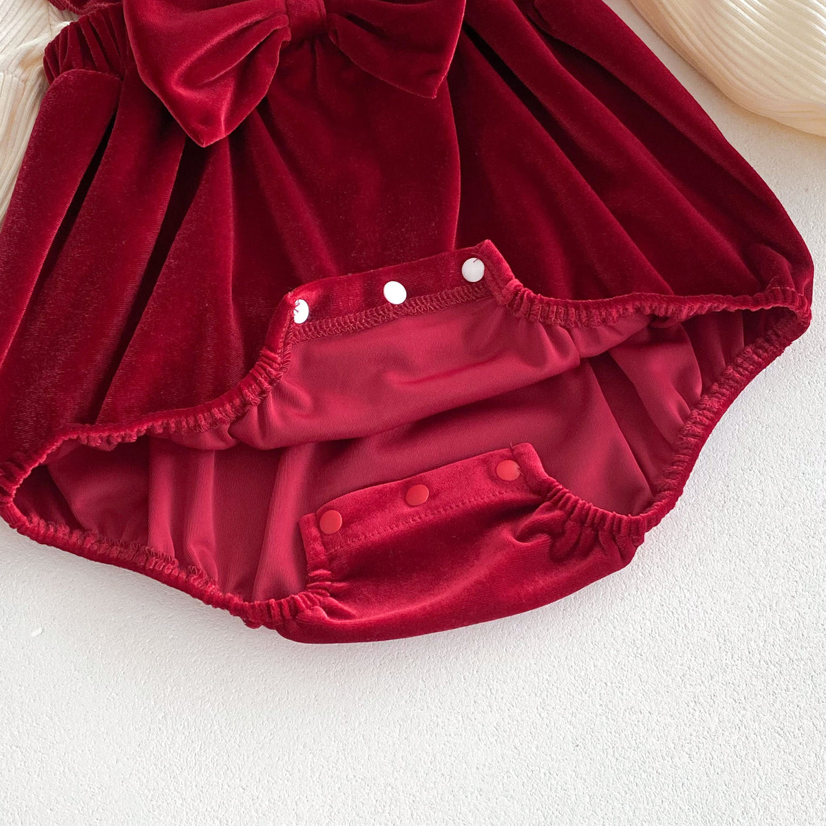 Close-up of snap crotch on red velvet romper