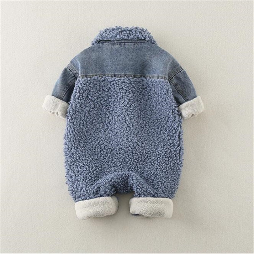 Alt text: "Back view of a cozy baby romper featuring soft blue sherpa fleece with denim accents on the shoulders and sleeves. This stylish winter romper has a fluffy texture throughout, while the denim yoke and rolled cuffs add a trendy, layered look. Designed for warmth and comfort, it’s perfect for keeping babies snug during colder months.