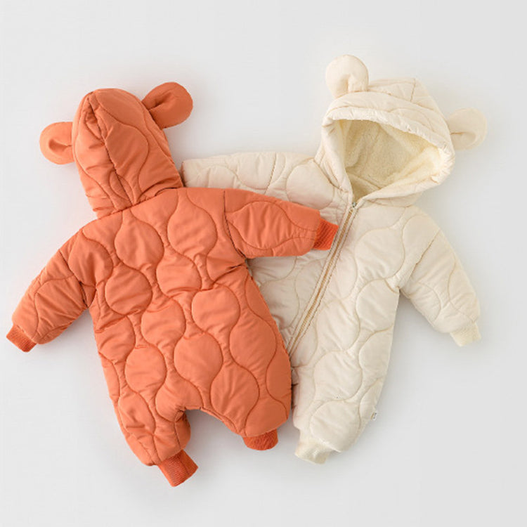 Two quilted baby jumpsuits, one in burnt orange and the other in cream, featuring bear ear hoods and fleece-lined interiors. The back view of the orange jumpsuit showcases its textured quilting pattern and adorable bear-ear details. Both jumpsuits are designed for warmth and comfort, ideal for chilly weather.