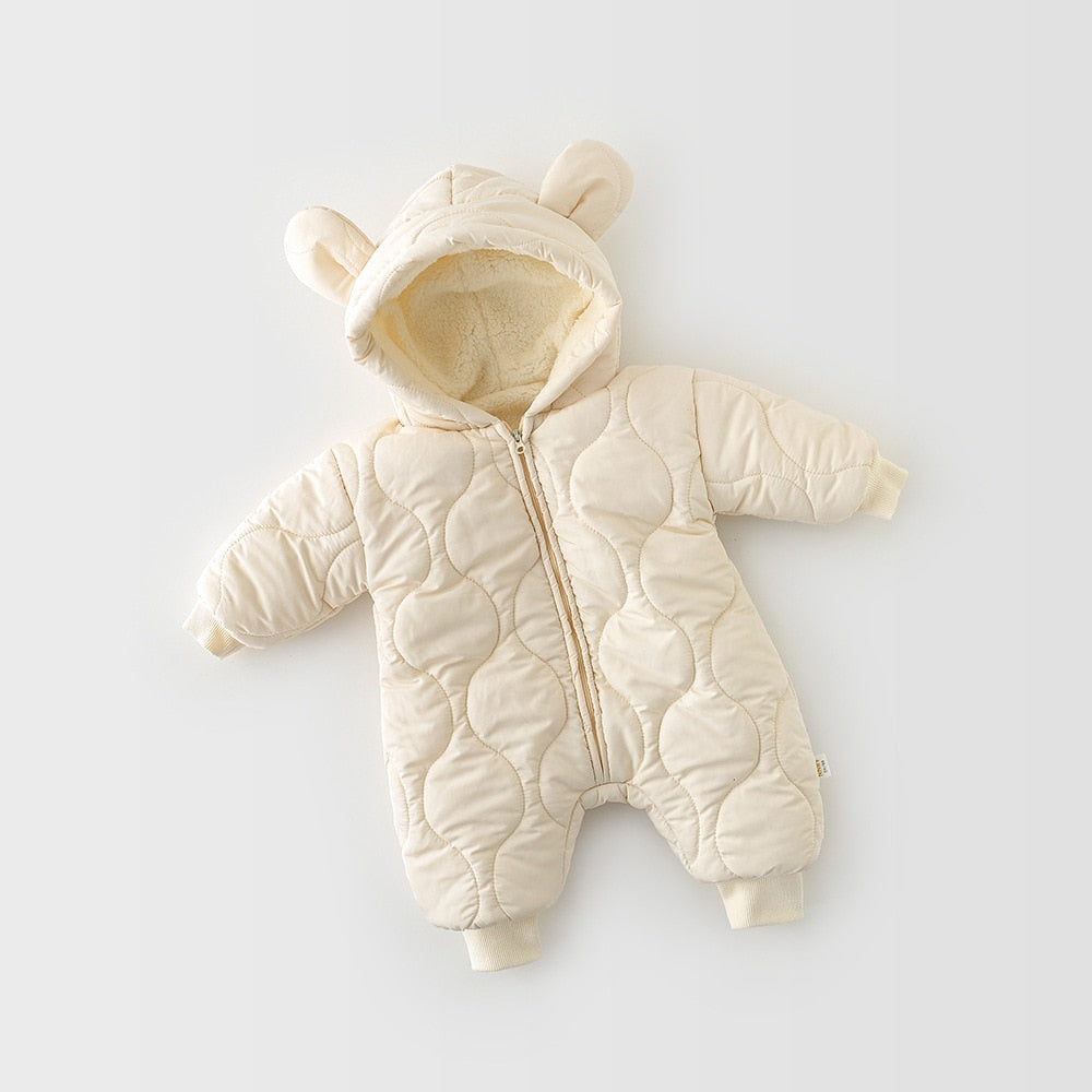 Full view of a cream-colored, quilted baby jumpsuit with a soft, fleece-lined hood featuring adorable bear ears. The jumpsuit is designed for warmth and comfort, with a cozy inner lining and ribbed cuffs on the wrists and ankles to keep out the cold, ideal for chilly days.