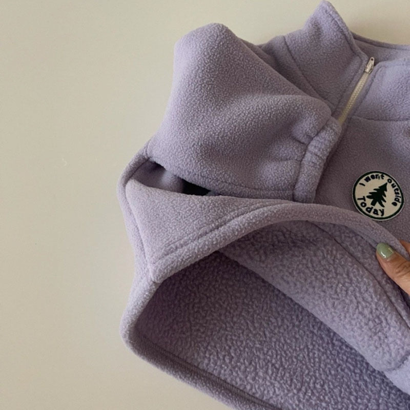 Half-zip stand collar detail on purple fleece pullover