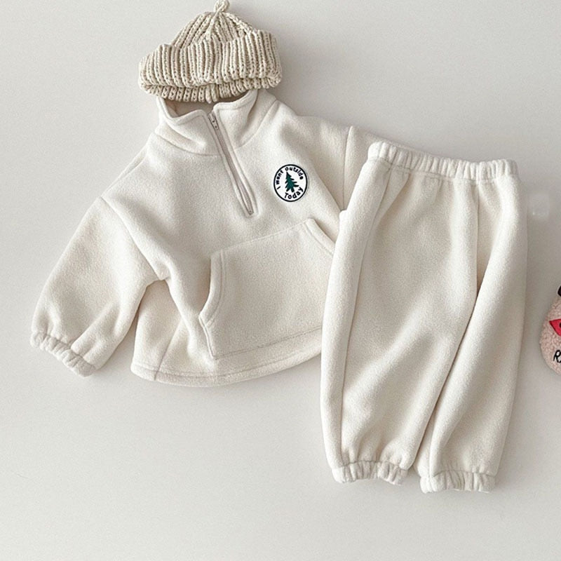 White polar fleece pullover and pants flat lay