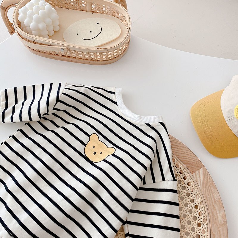 Close-up of bear appliqué on black and white stripes