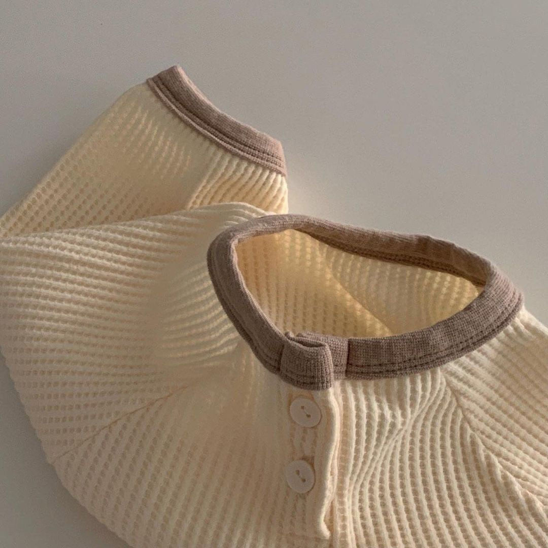 Close-up of beige waffle knit romper neckline
