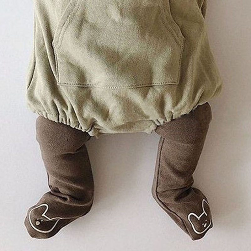 Baby wearing brown bear face footed leggings