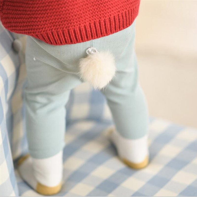 Baby wearing green bunny tail leggings