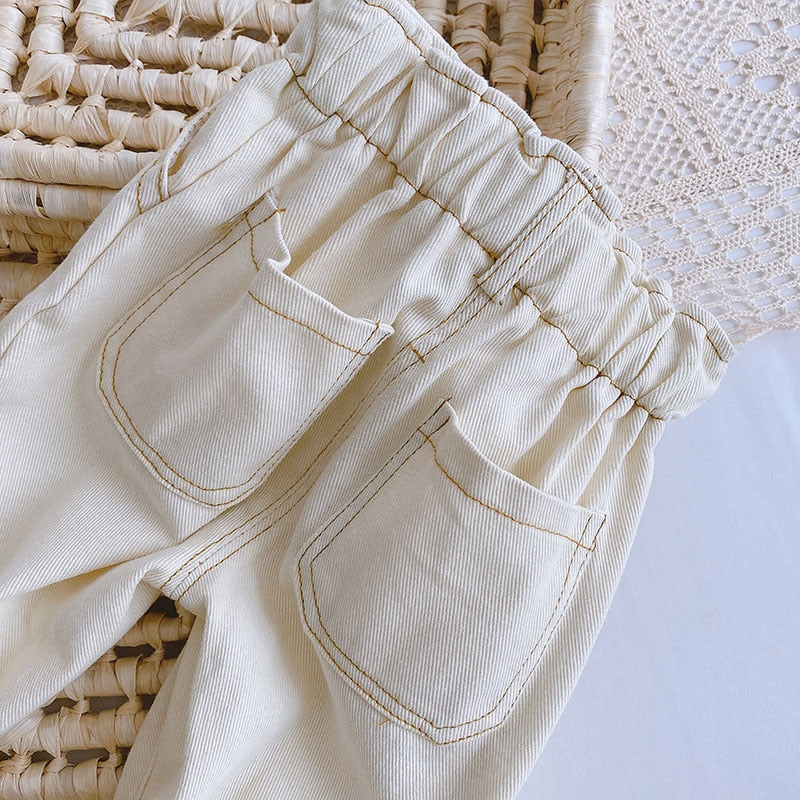 Back pockets on beige denim pants