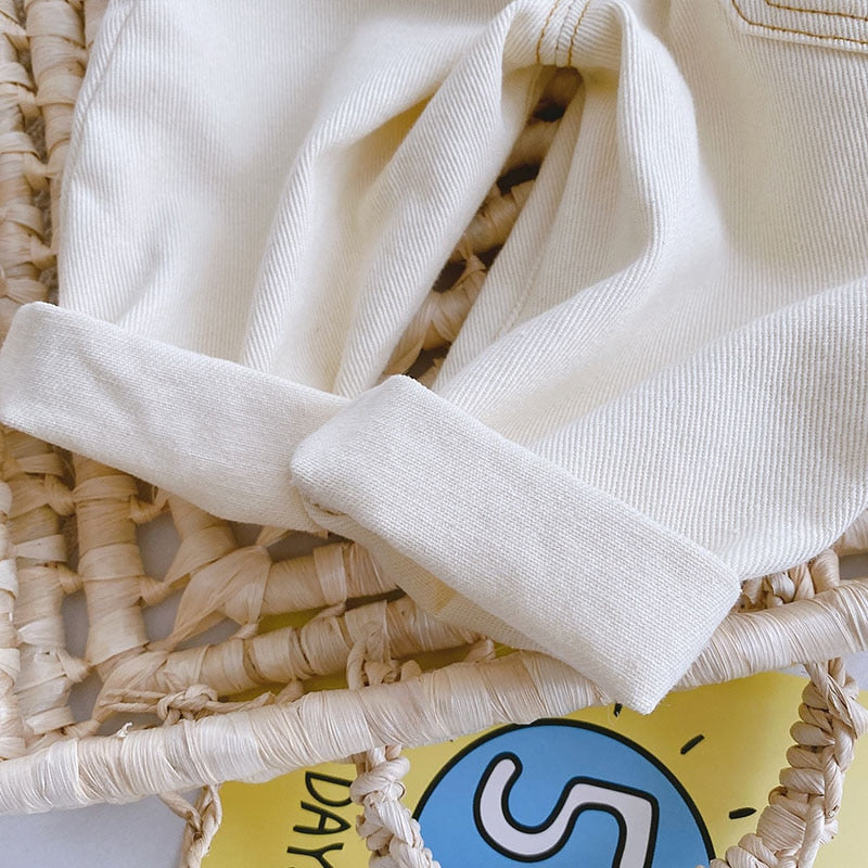 Close-up of rolled cuff on beige denim