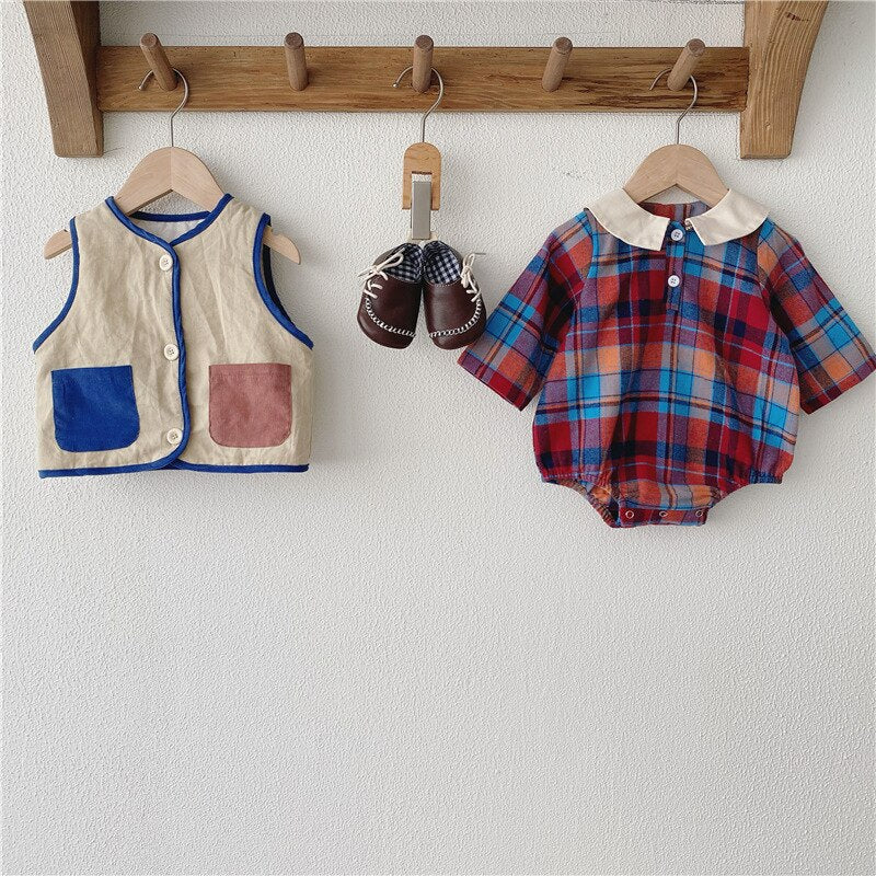 Beige vest and blue plaid romper on hooks