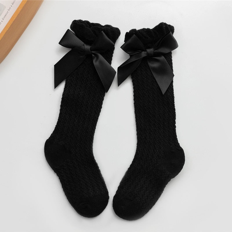 Black openwork knee socks with satin bows